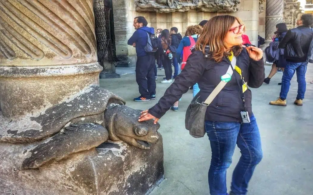 a sagrada familia tour guide explains a column at the nativity façade