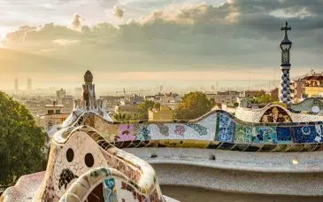 the view of the city and sea from the mosaic benches at park guell barcelona