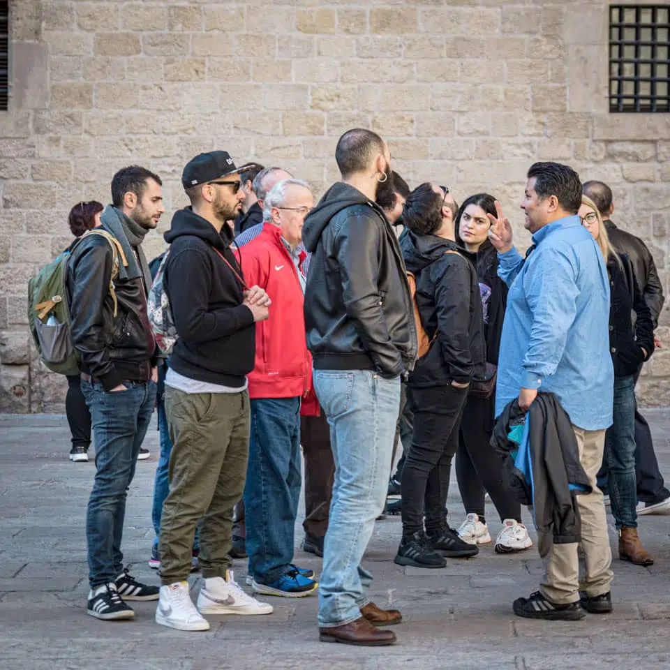 tourists listening to tour guide alvaro garza in the gothic quarter barcelona spain