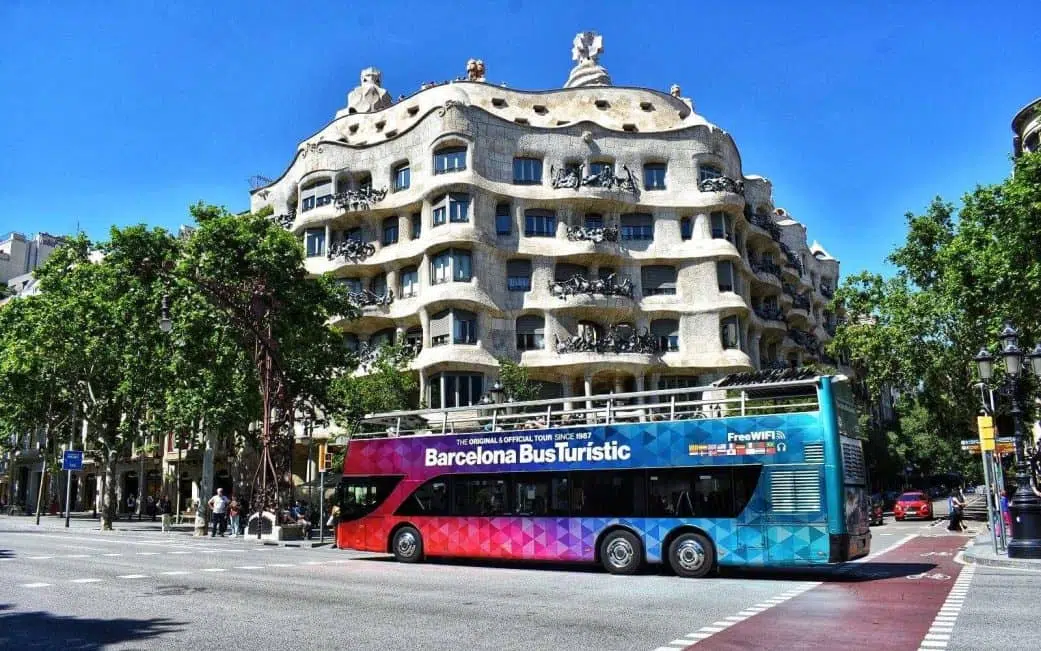 barcelona hop on hop off bus passing by la pedrera on passeig de gracia