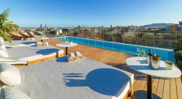 pool roof terrace with view of barcelona skyline from a five star hotel in barcelona spain
