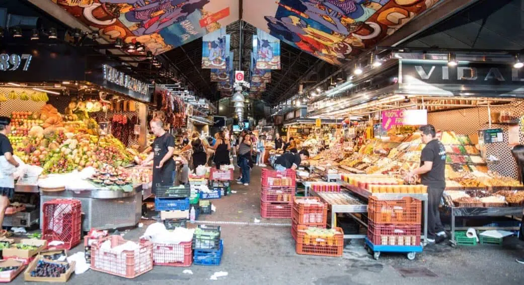 vendors sorting through products at boqueria market barcelona