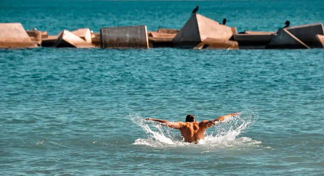 a tourist swimming at one of the best beaches in barcelona spain