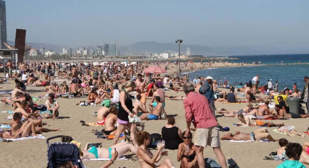 large crowds at the peak of summer at barceloneta beach