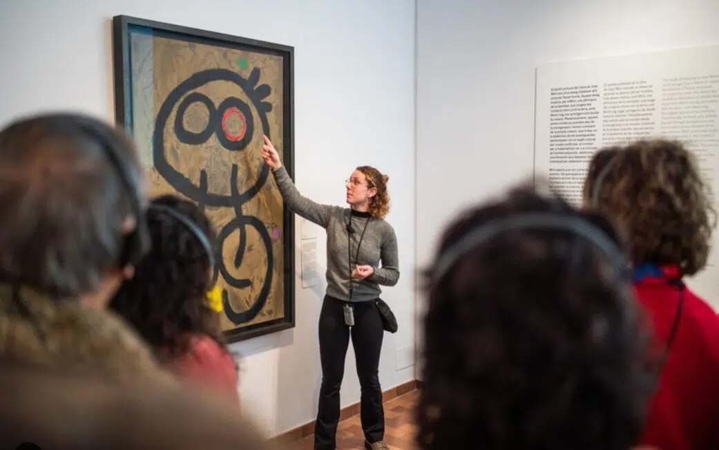 a guide explains a painting at the joan miro museum in barcelona