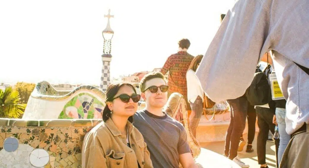 two tourists getting their photo taken on a sagrada familia and park guell tour of barcelona spain