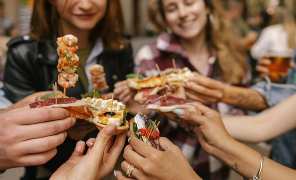 a group enjoys a variety of tapas on a barcelona tapas tour.