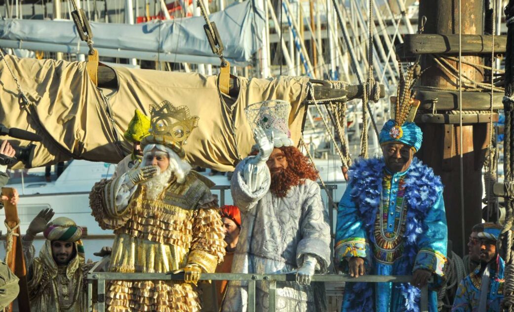 three kings waving at a parade in barcelona spain