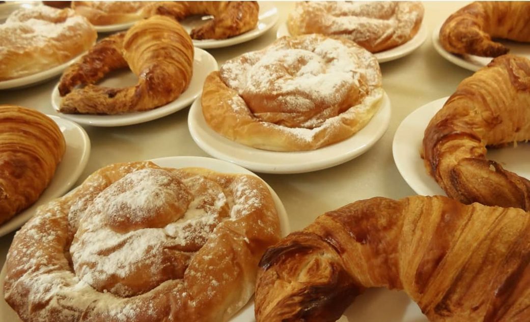 a table of breakfast pastries at granja viader in barcelona